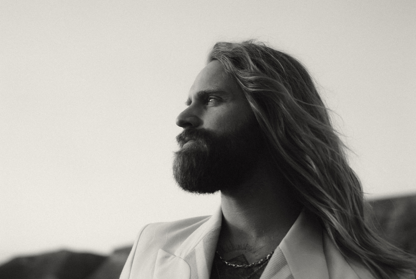 Musician Sam Ruder facing left in black and white.